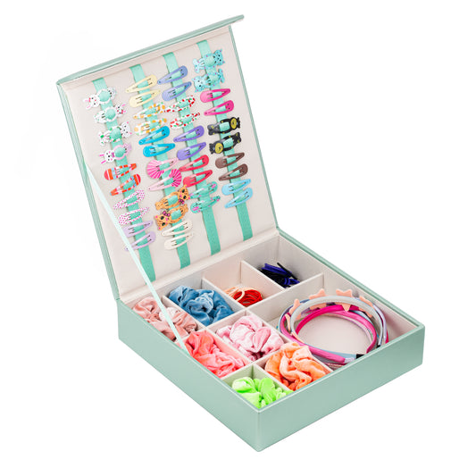 The mint green hair accessory organiser is shown at an angle. The storage box is open and shows a beautiful display of girl’s hair accessories. The backdrop is white.