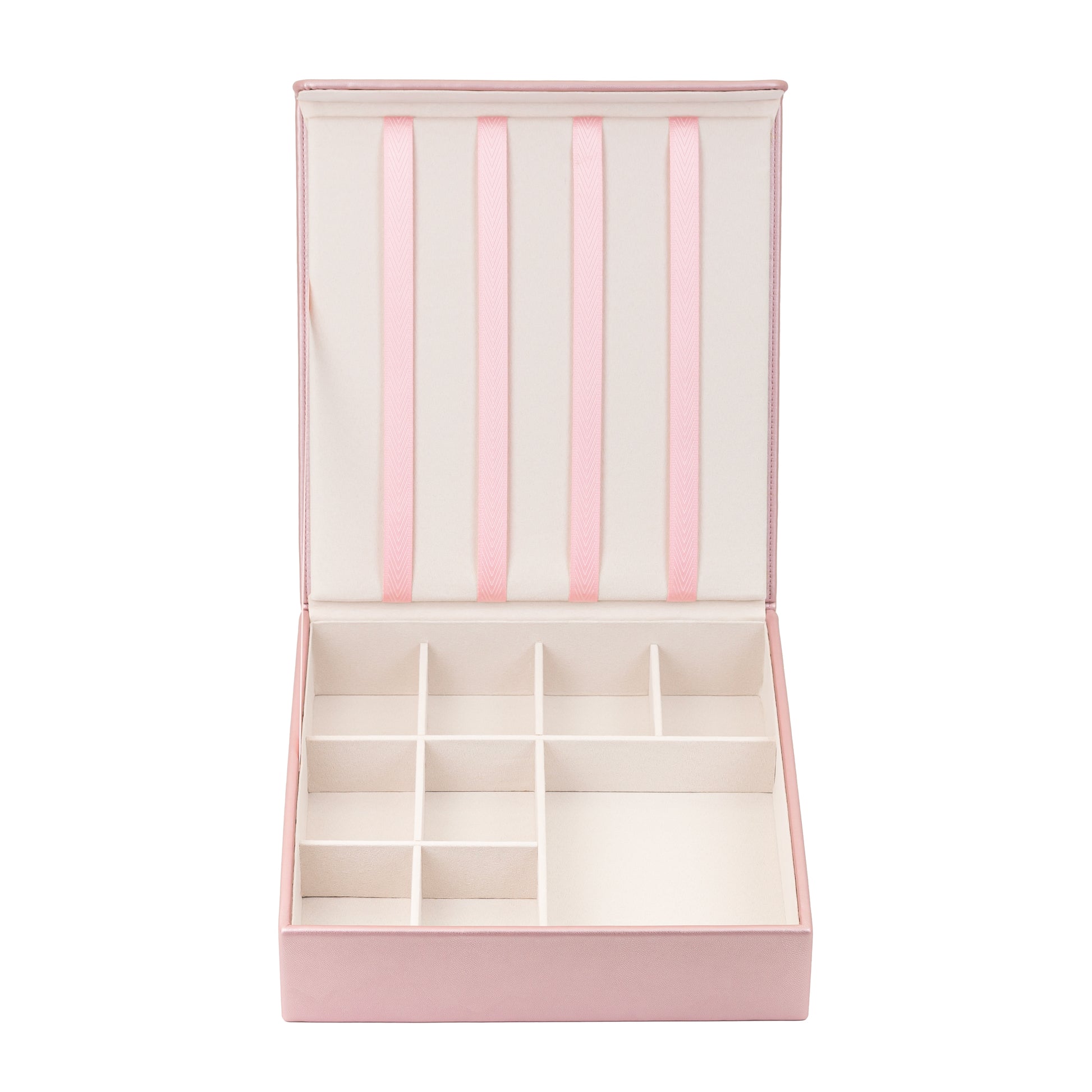 The pink hair accessory organiser is shown against a white background. The box is empty and clearly shows the 4 ribbons attached to the lid which are designed to hold hair clips, and the grid in the bottom half which is designed to store hair bands, barrettes, hair bobbles and scrunchies